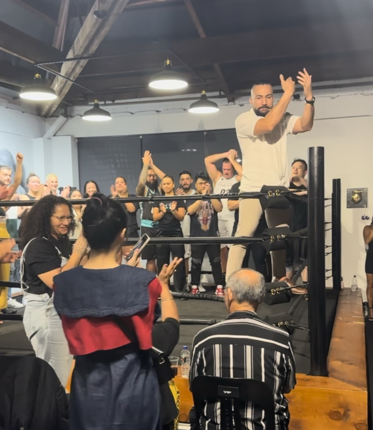 Pad Flow members applauding around the boxing ring