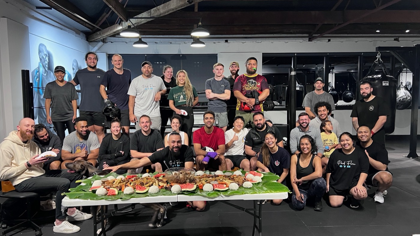 Pad Flow members gathered around a shared meal in the gym