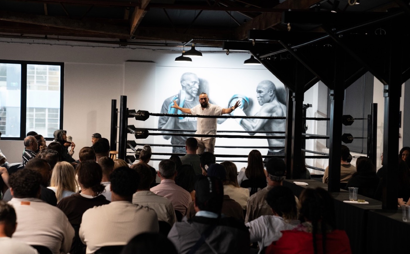 A Pad Flow coach addressing members from inside the boxing ring