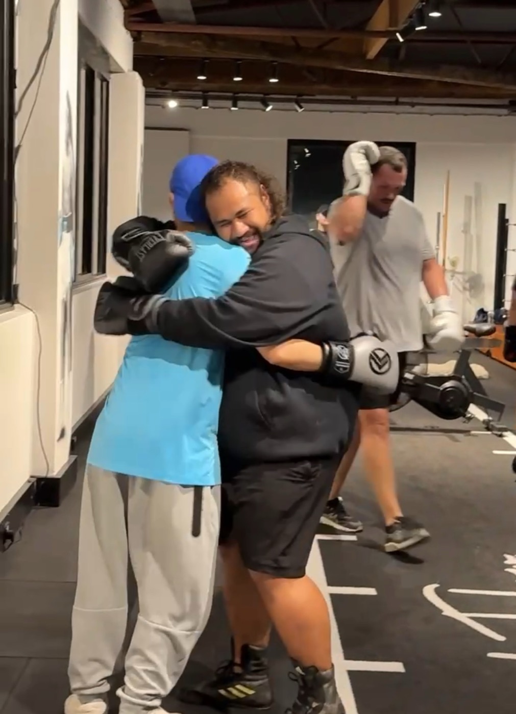 Pad Flow members hugging after a class