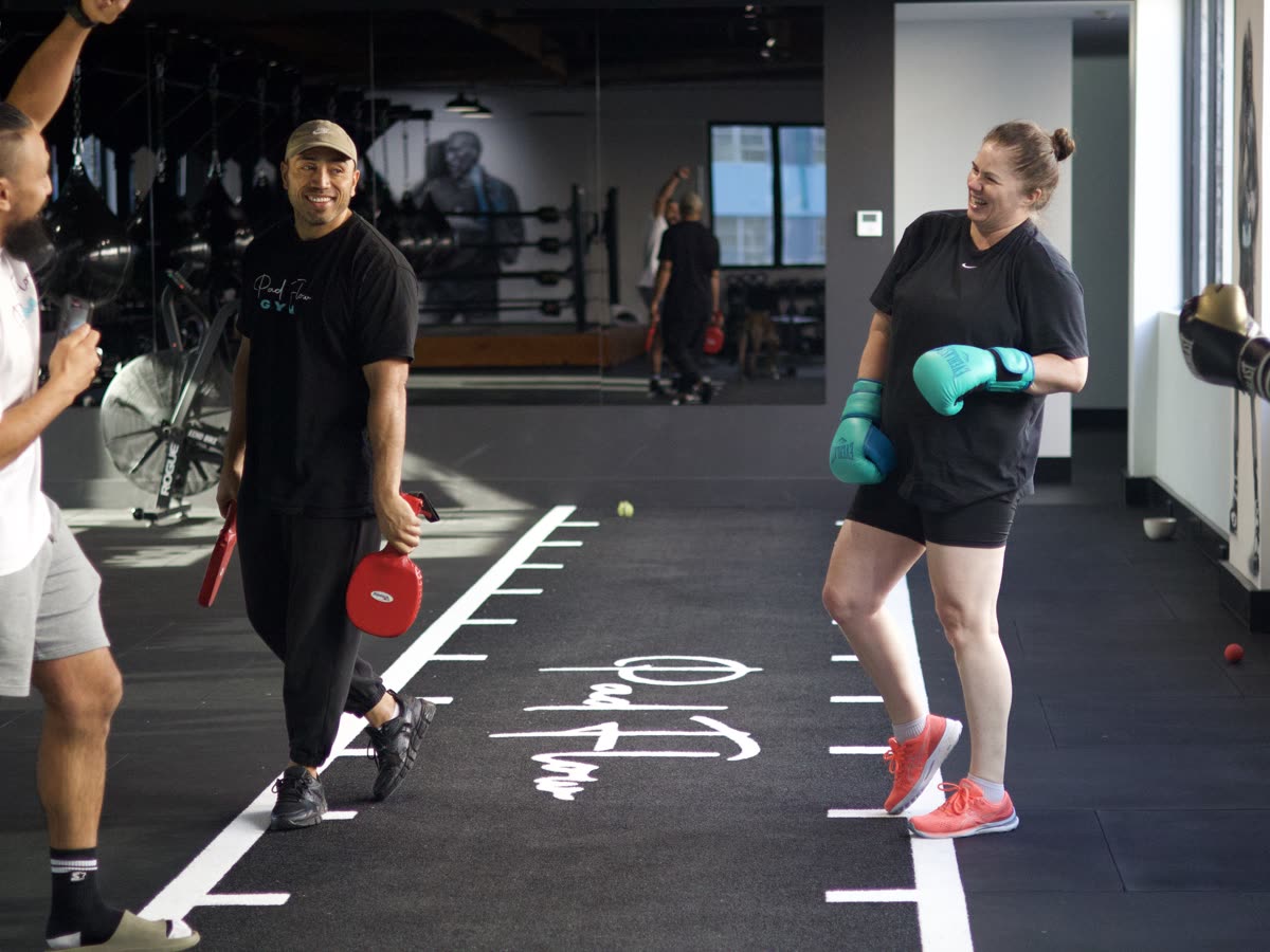 Pad Flow coach and member laughing together in the gym